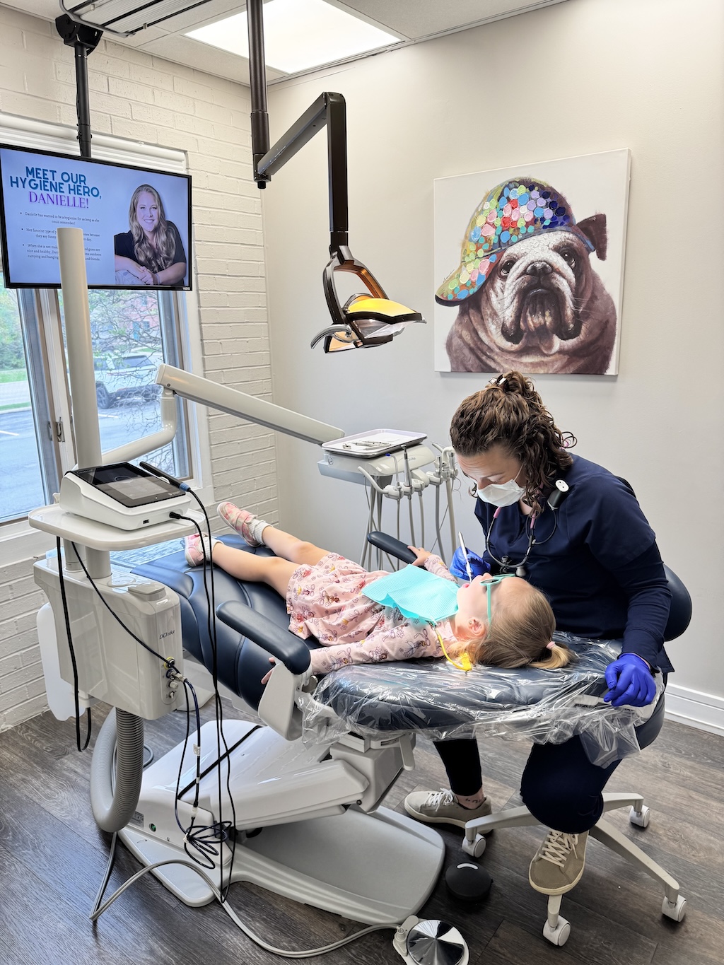 Dr. Erica Zolnierczyk, DMD examining a pediatric patient at Inspire Dental Wellness in Orland Park, IL